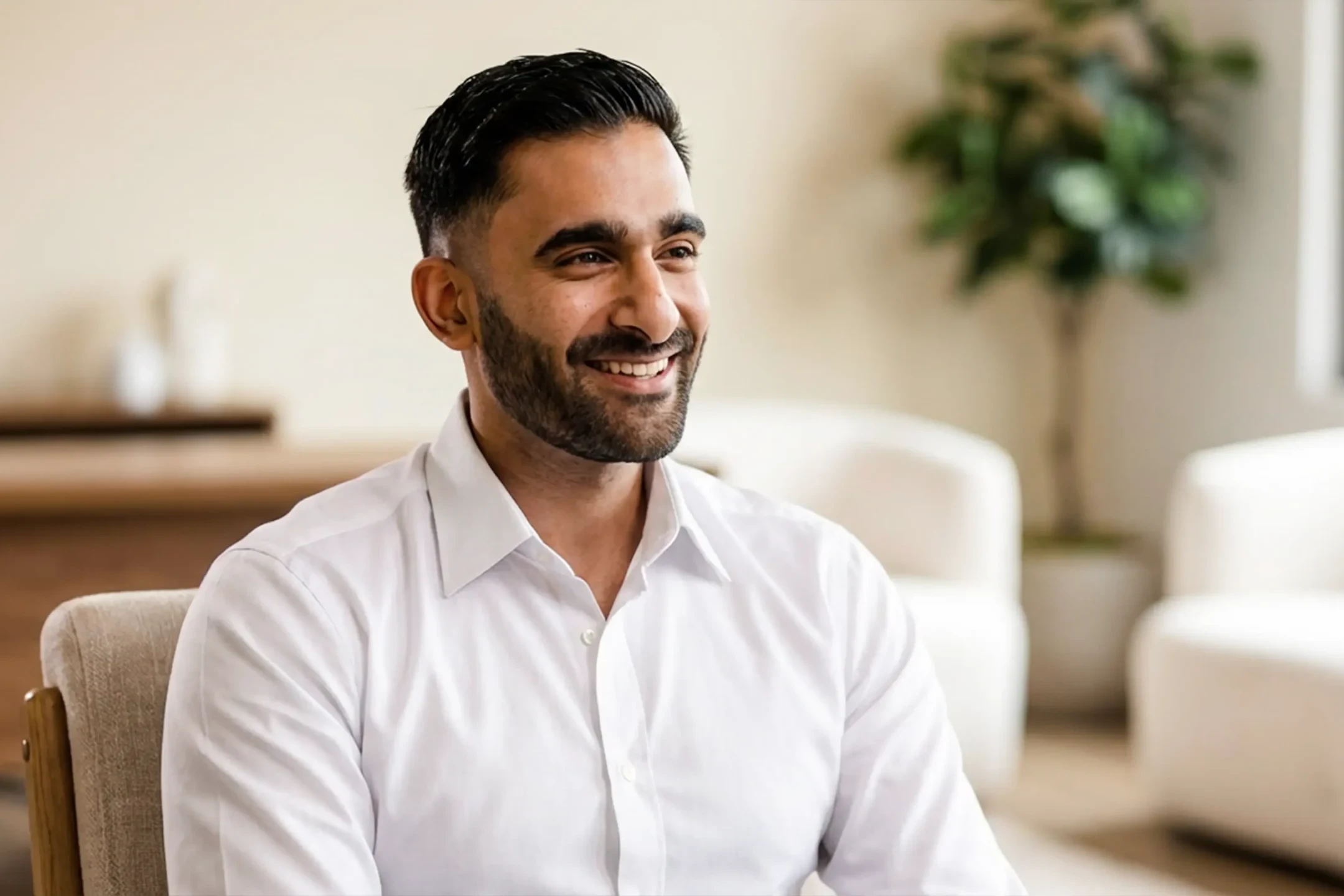 Interview-style photo of Aron Wadhia smiling, highlighting his story about professional growth and internal mobility at Ramtech.