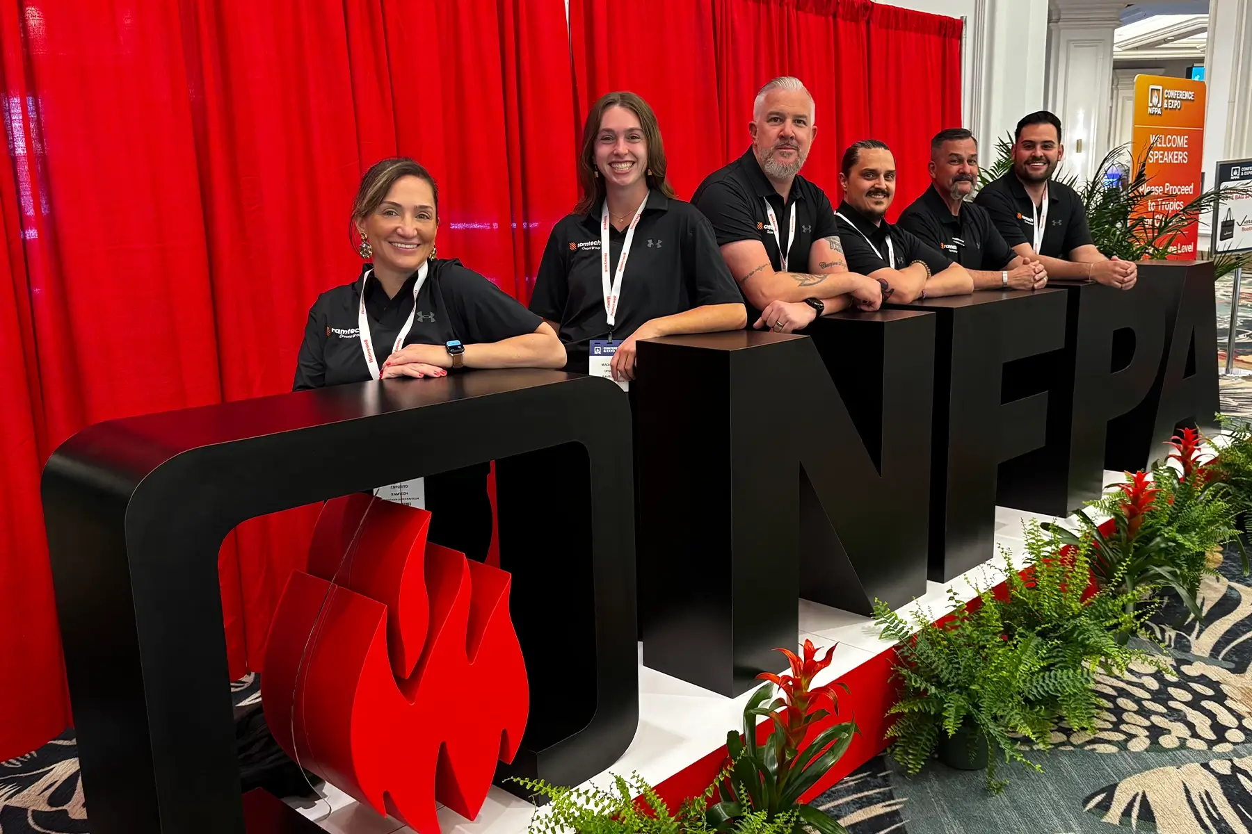 James Pecz leadership promotion: The Ramtech team stands proudly behind large black 